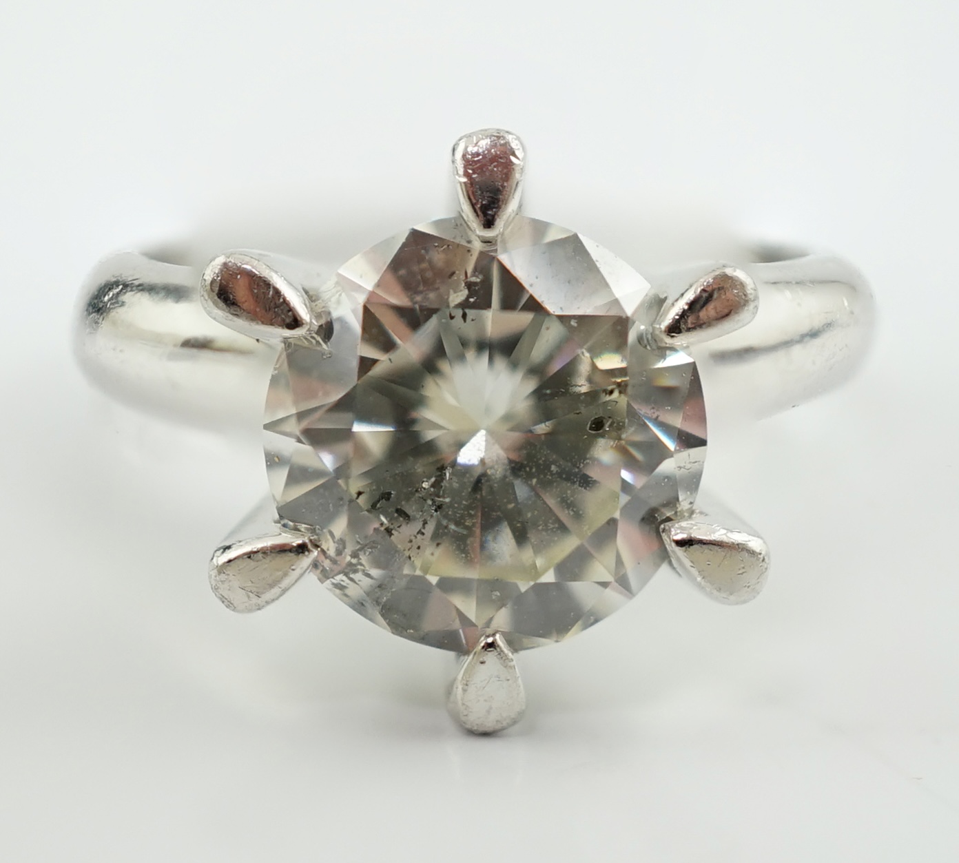 A modern platinum and solitaire diamond set ring
